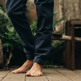 our fit model wearing The Après Pant in Navy Seersucker—cropped shot from knees down