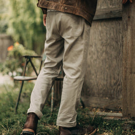 our fit model wearing The Chore Pant in Ash Boss Duck—back shot, near shed