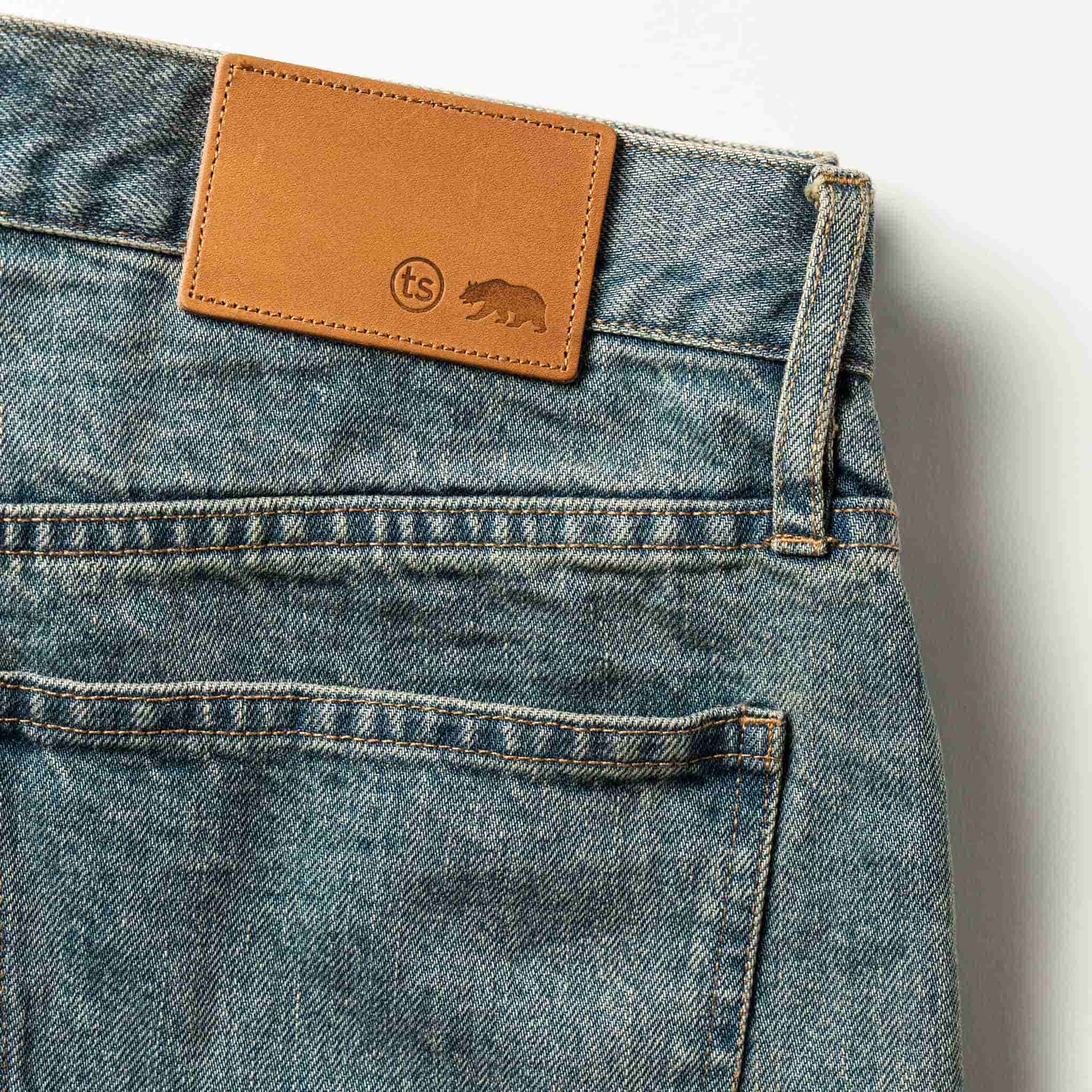 material shot of The Democratic Jean in 24-Month Wash Japanese Selvage—leather patch closeup, Denim by Taylor Stitch