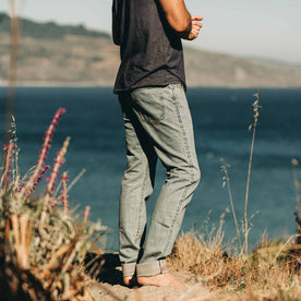 our fit model wearing The Slim Jean in 24-Month Wash Japanese Selvage—facing ocean