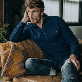 fit model wearing The Corso in Indigo Double Cloth, sitting on couch