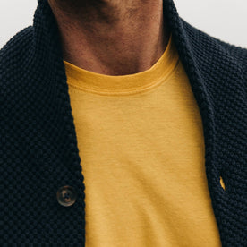fit model wearing The Cotton Hemp Tee in Gold, sweater overlaying