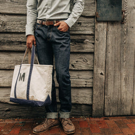 fit model wearing The Democratic Jean in Organic Selvage, cuffed, hand in pocket