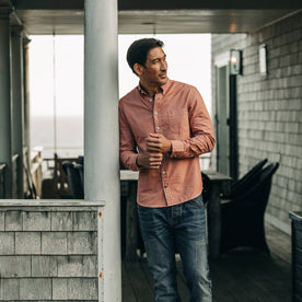 fit model rocking The Jack in Dusty Rose Oxford, leaning against beam of house