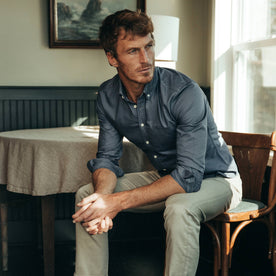 fit model wearing The Jack in Ocean Oxford, sitting, hands clasped