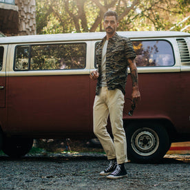 fit model wearing The Jungle Shirt in Tiger Camo, weaing chucks, looking at camera 