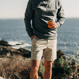 fit model wearing The Morse Short in Aluminum Slub Linen, drinking water on coast