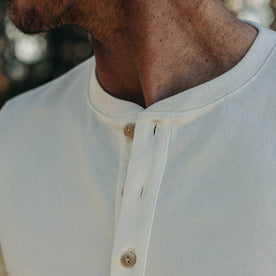 fit model wearing The Short Sleeve Heavy Bag Henley in Natural, detail of collar
