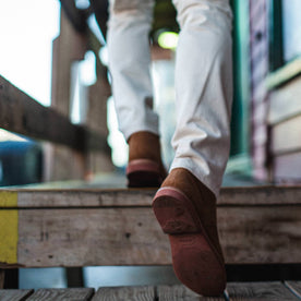 fit model wearing The Trench Boot in Butterscotch Weatherproof Suede, walking up stairs, Footwear by Taylor Stitch
