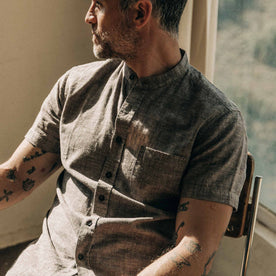 our fit model wearing The Short Sleeve Bandit in Tobacco Hemp, sitting back looking right