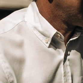 our fit model wearing The Short Sleeve Jack in Washed White Oxford outside on a fence—closeup shot of collar