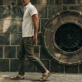 fit model wearing The Democratic All Day Pant in Olive Bedford Cord, walking left