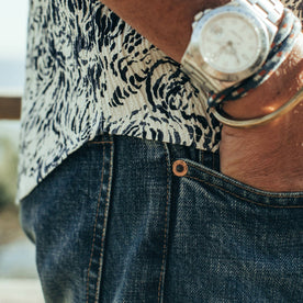 fit model wearing The Democratic Jean in Organic Selvage 12-month Wash, side shot up close