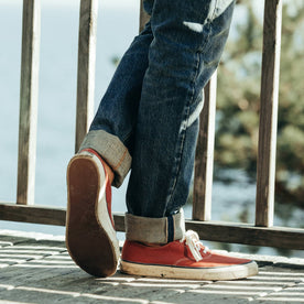 fit model wearing The Democratic Jean in Organic Selvage 12-month Wash, cuffed over shoes