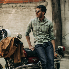 fit model wearing The Jack in Moss Plaid, sitting on motorcycle