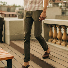 fit model wearing The Slim All Day Pant in Olive Bedford Cord, walking down steps
