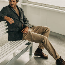 our fit model wearing The Camp Pant in Khaki Reverse Sateen—sitting on a bench