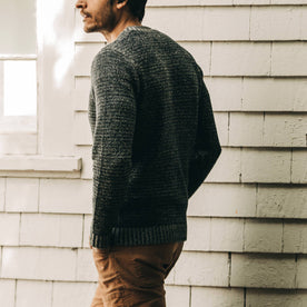 our fit model wearing The Headland Sweater in Marled Navy—walking left