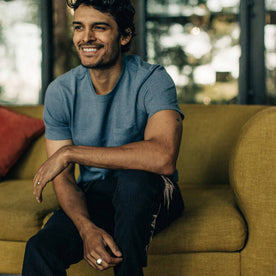 our fit model wearing The Heavy Bag Tee in Slate—cropped shot looking out, smiling