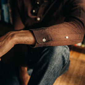 our fit model relaxing in The Jack in Brushed Rust Oxford—cropped shot of sleeve