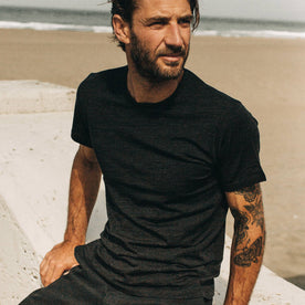 our fit model wearing The Merino Tee—in our black colorway, looking right