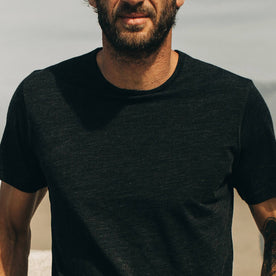 our fit model wearing The Merino Tee—in our black tee looking straight on, cropped shot