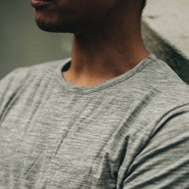 our fit model wearing The Merino Tee—in the grey colorway, cropped shot of chest