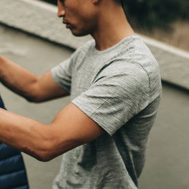 our fit model wearing The Merino Tee—in our grey colorway, cropped shot of shoulder