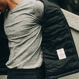 our fit model wearing The Merino Tee—in our grey colorway paired with a jacket