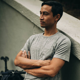 our fit model wearing The Merino Tee—in our grey shirt, arms crossed