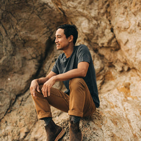 our fit model wearing The Merino Tee—cropped shot sitting down