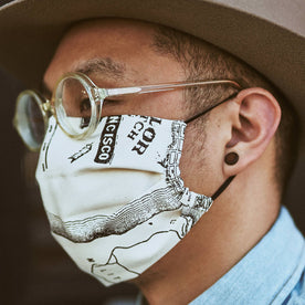our fit model wearing The Pleated Mask in SF Map Print—cropped shot of face looking left