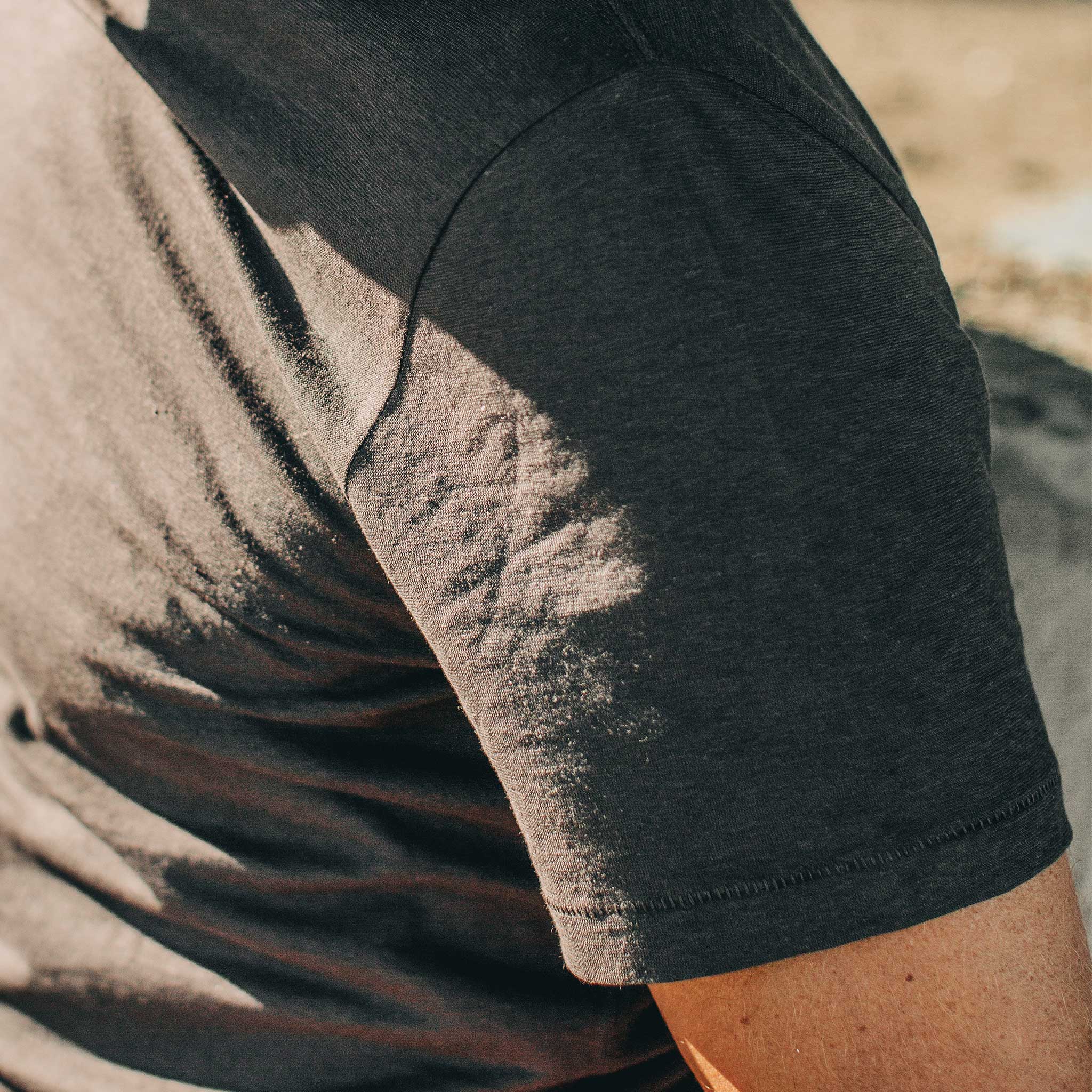 our fit model wearing The Standard Issue Tee in Charcoal Hemp—sleeve shot, Knits by Taylor Stitch