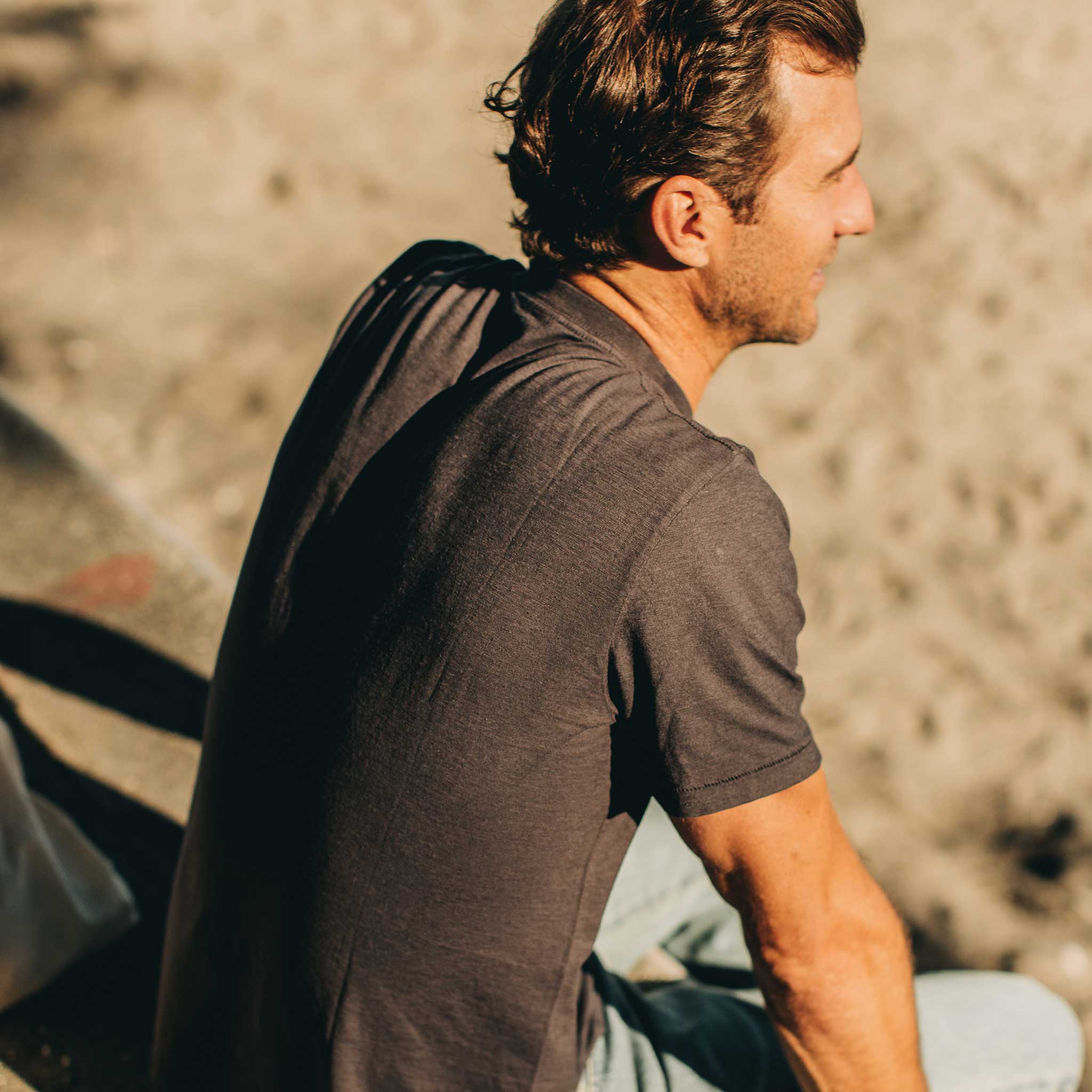 our fit model wearing The Standard Issue Tee in Charcoal Hemp—back shot at an angle, Knits by Taylor Stitch