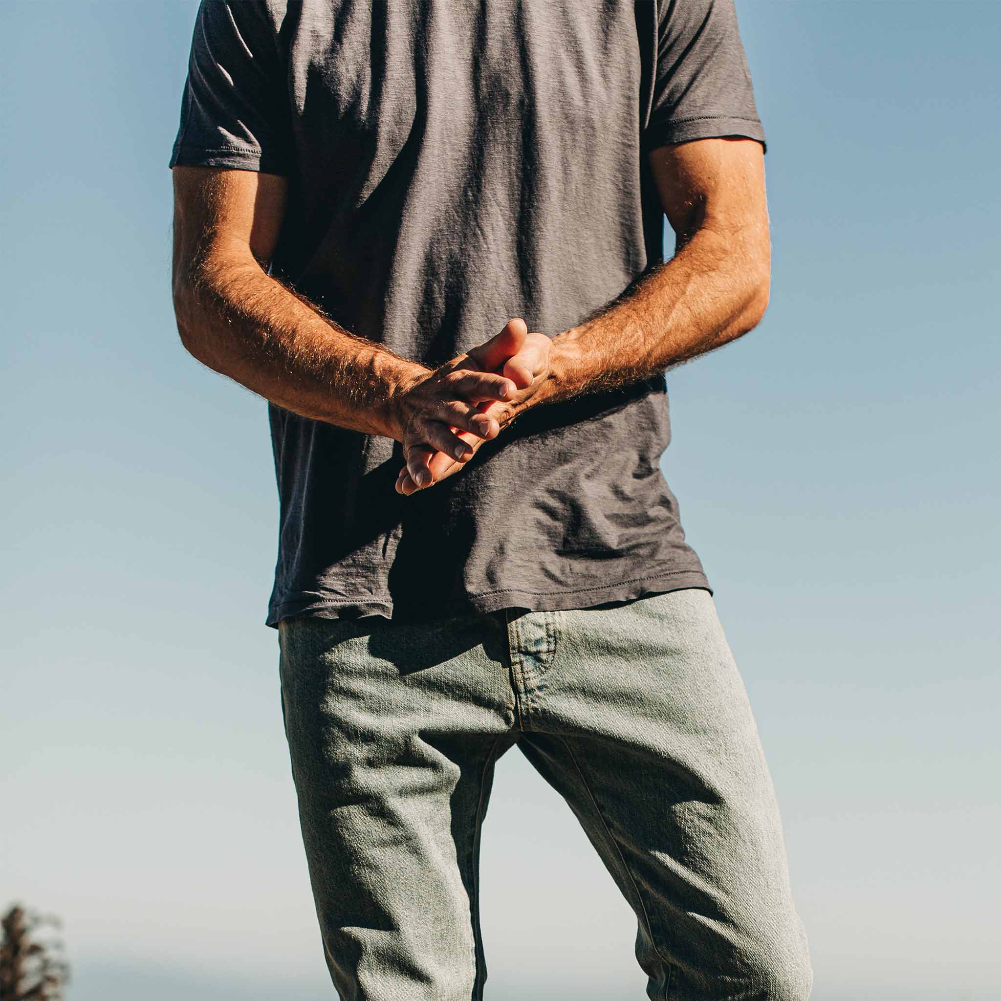 our fit model wearing The Standard Issue Tee in Navy Hemp—cropped shot from chest down, Knits by Taylor Stitch