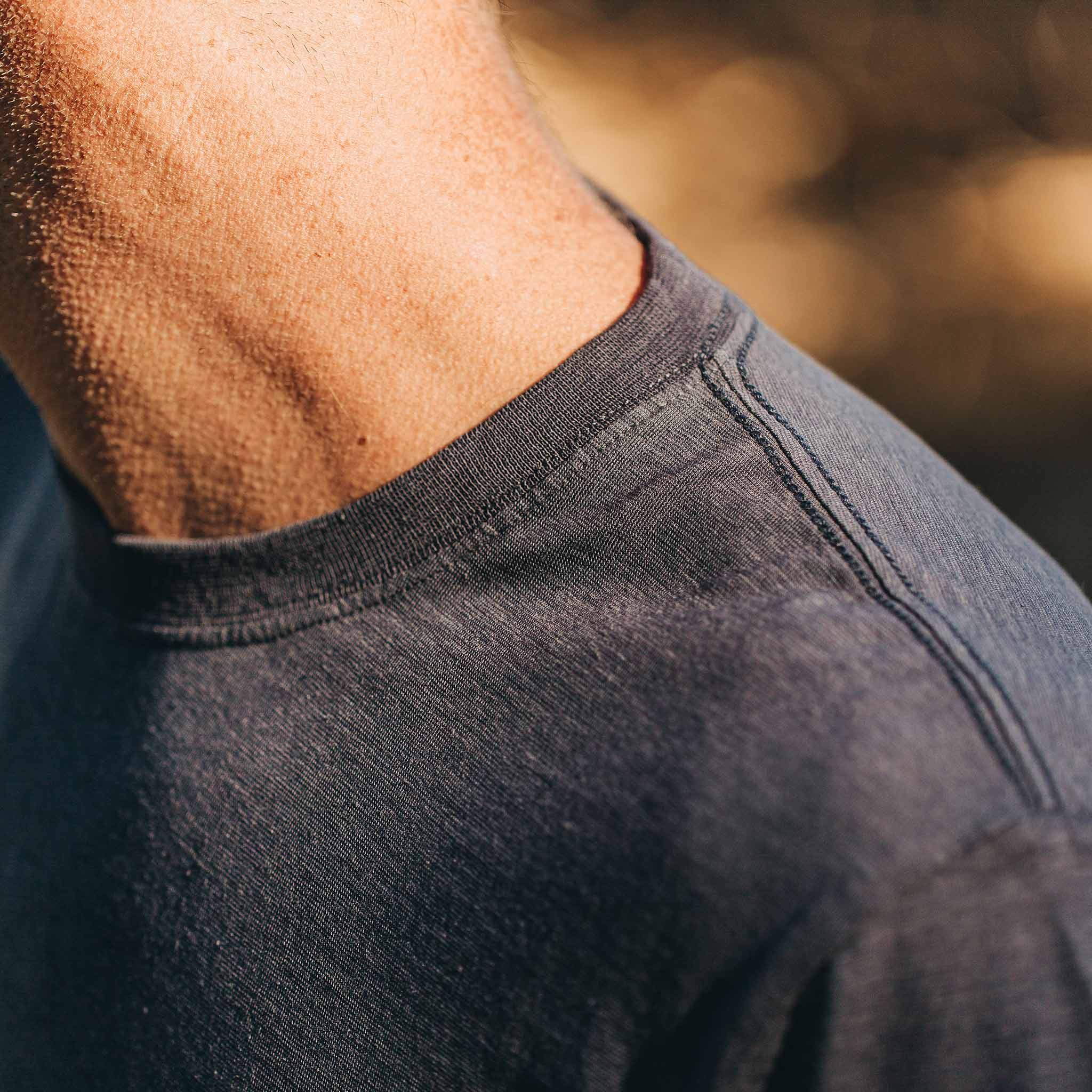 our fit model wearing The Standard Issue Tee in Navy Hemp—cropped shot of shoulder and collar, Knits by Taylor Stitch