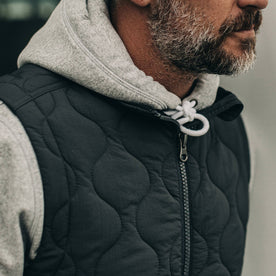 our fit model wearing The Vertical Vest in Charcoal—cropped shot of chest