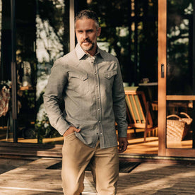 our fit model wearing The Western Shirt in Olive Melange—on a deck, hand in pocket