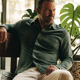 fit model wearing The California in Sea Green Pique, sitting, looking right