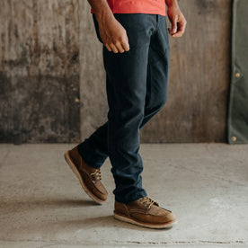 fit model wearing The Chore Pant in Coal Boss Duck, with boots