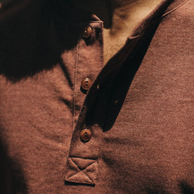 fit model wearing The Heavy Bag Henley in Burgundy, button detail