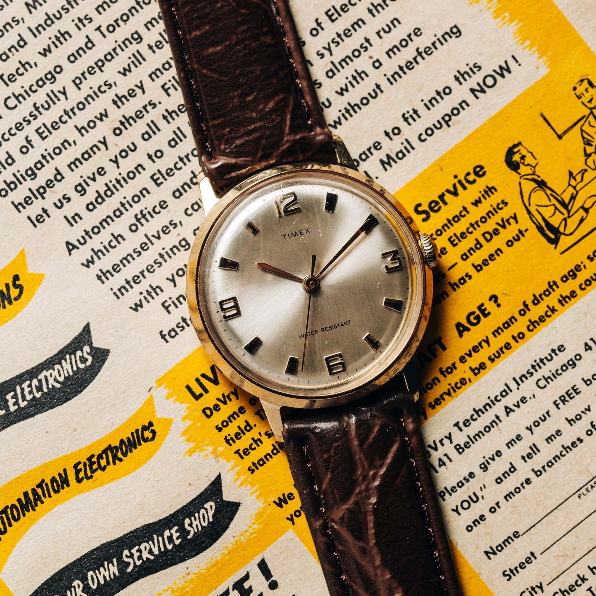 flatlay of the 1969 Timex Marlin, on an old magazine, Accessories by Taylor Stitch