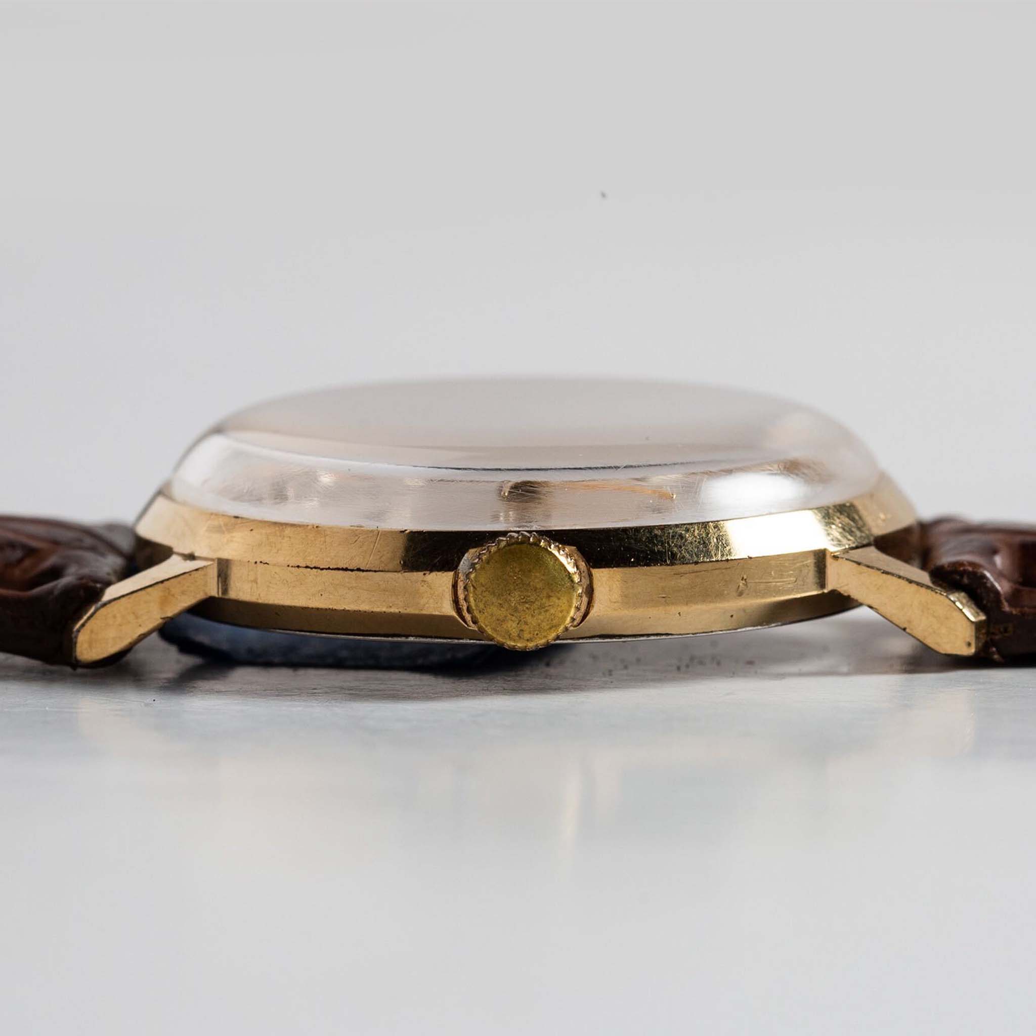 flatlay of the 1969 Timex Marlin, shown from the side, Accessories by Taylor Stitch