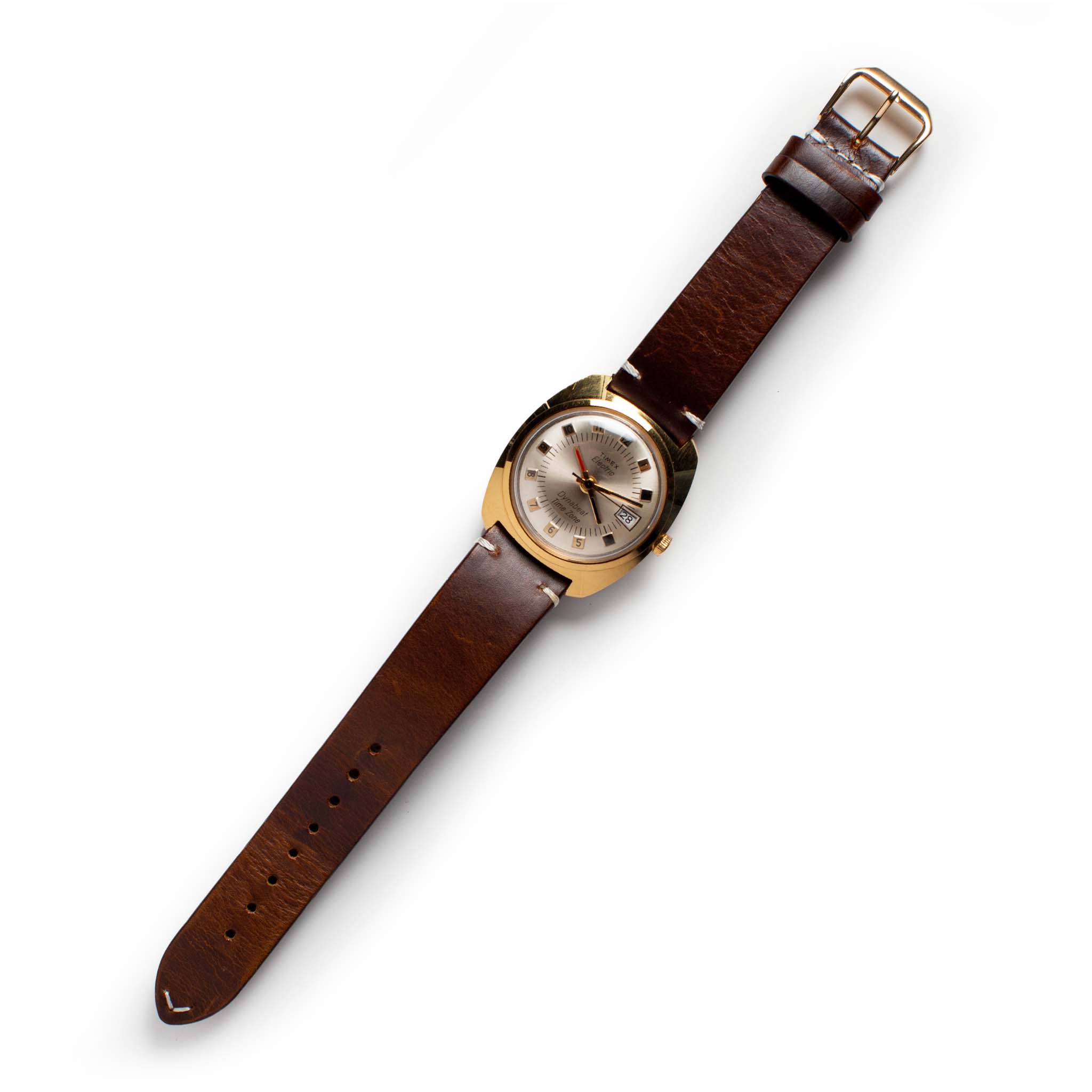 flatlay of the 1975 Timex Electric Dynabeat Time Zone, Accessories by Taylor Stitch