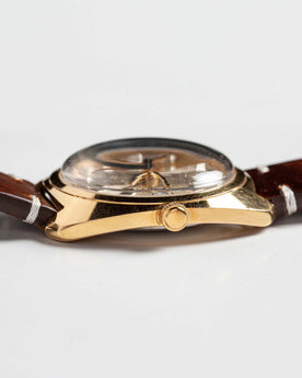 flatlay of 1975 Timex Electric Dynabeat Time Zone, shown from the side, Accessories by Taylor Stitch