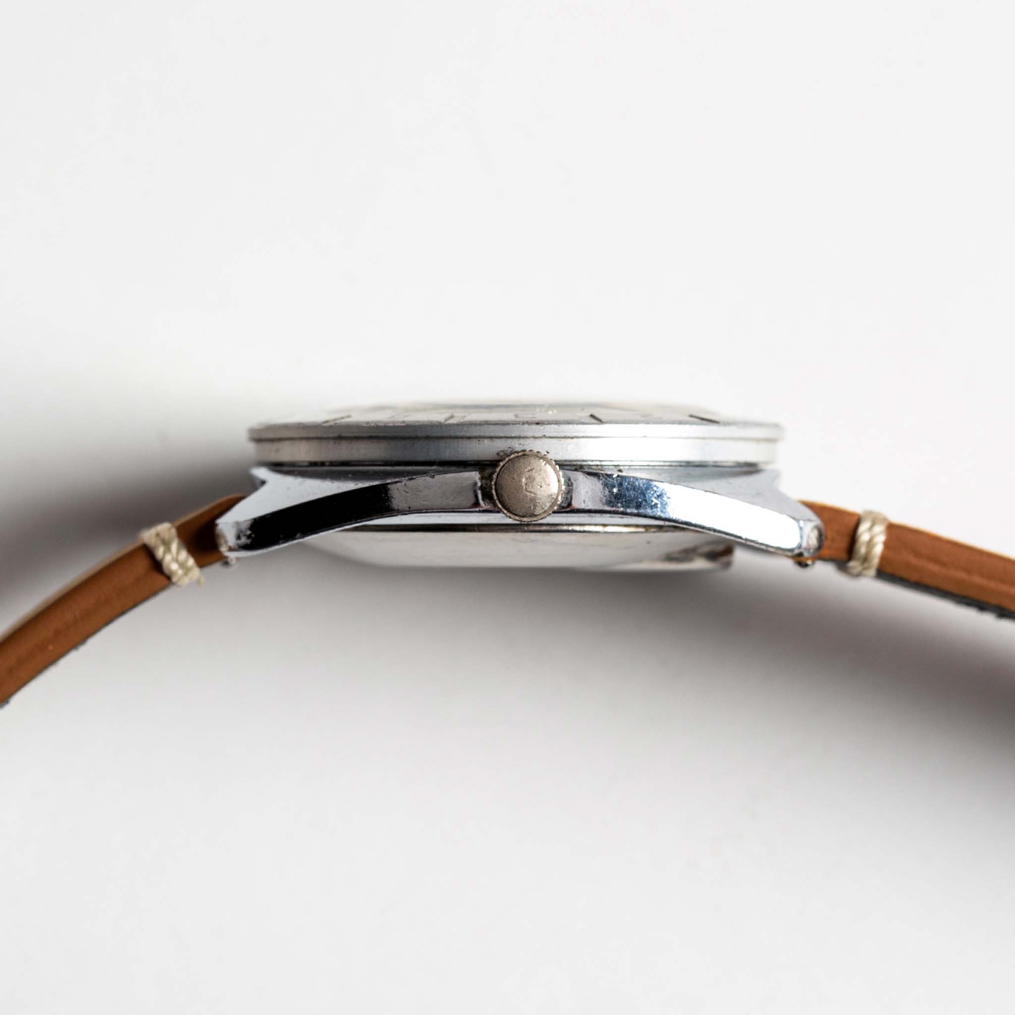 flatlay of 1976 Timex Electric Dynabeat, shown from the side, Accessories by Taylor Stitch