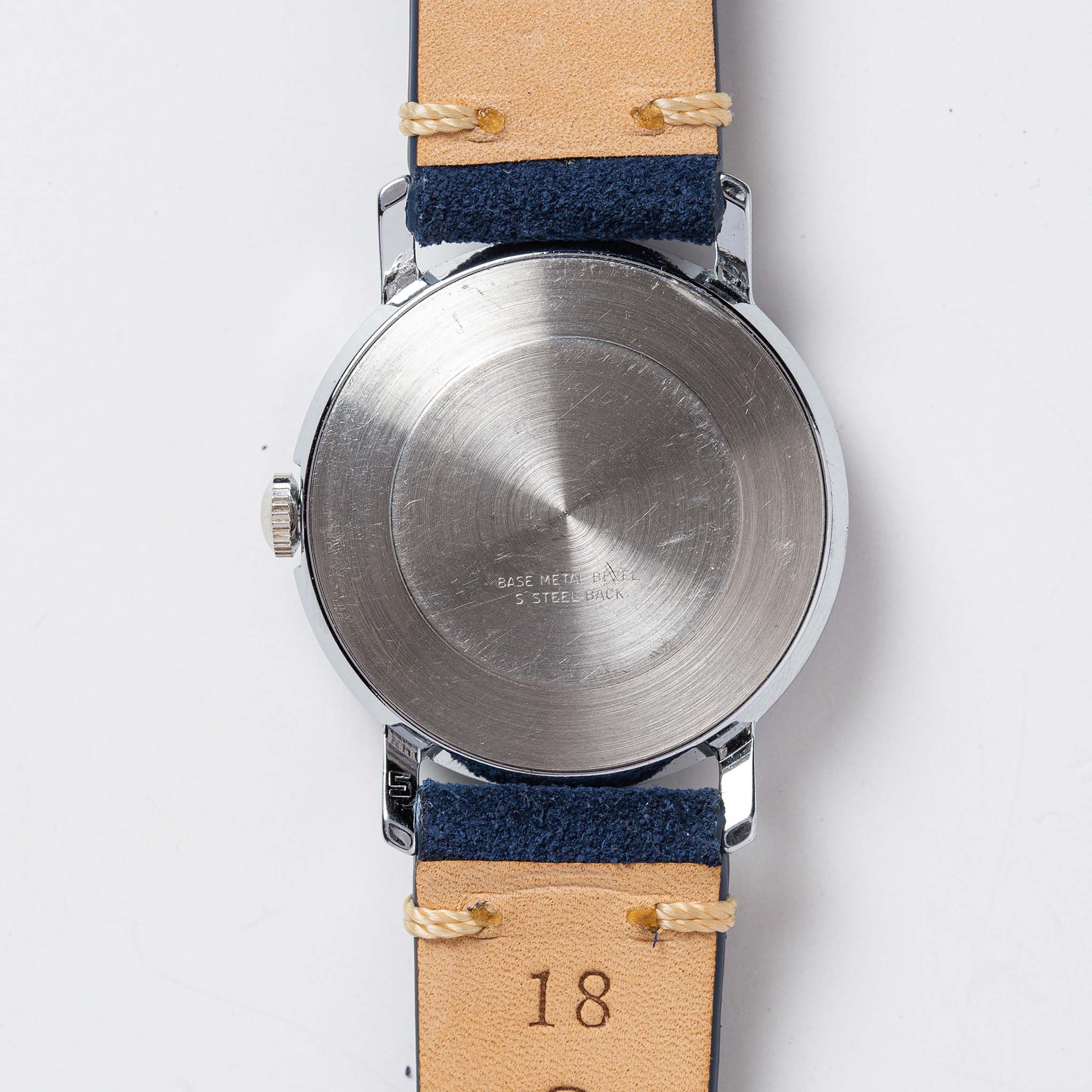 flatlay of the 1976 Timex Mercury Blue, shown from the back, Accessories by Taylor Stitch