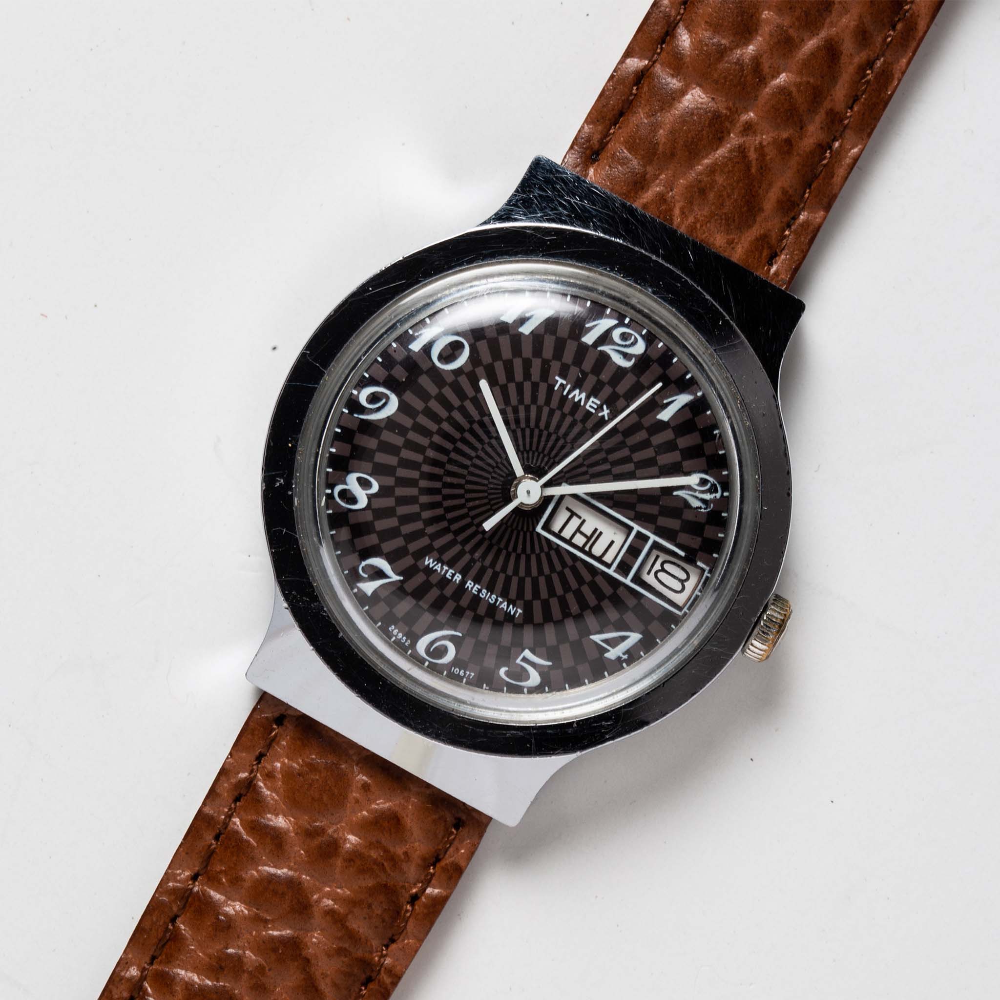 flatlay of the 1977 Timex Marlin, shown close up, Accessories by Taylor Stitch
