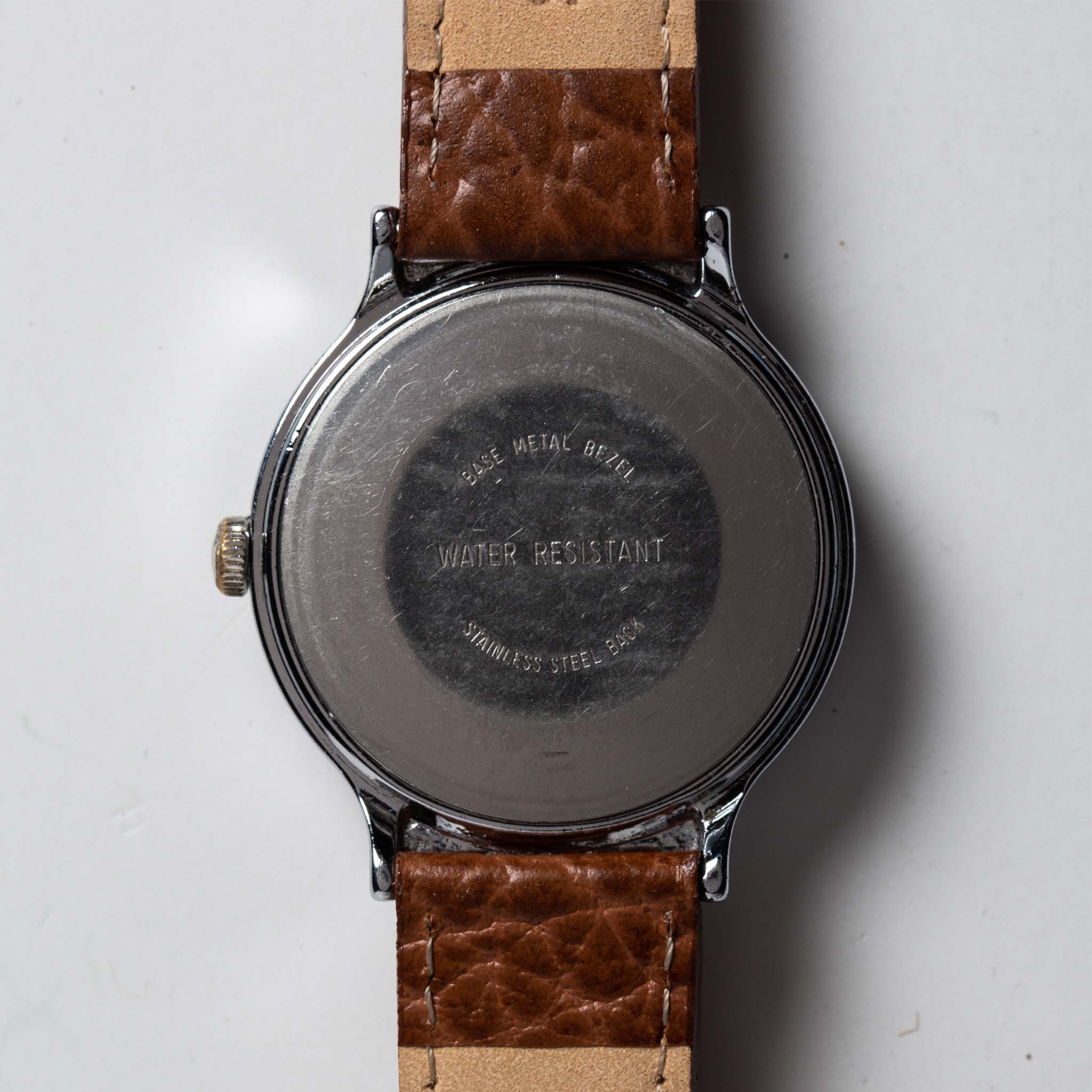 flatlay of the 1977 Timex Marlin, shown from the back, Accessories by Taylor Stitch