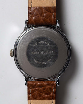 flatlay of the 1977 Timex Marlin, shown from the back, Accessories by Taylor Stitch